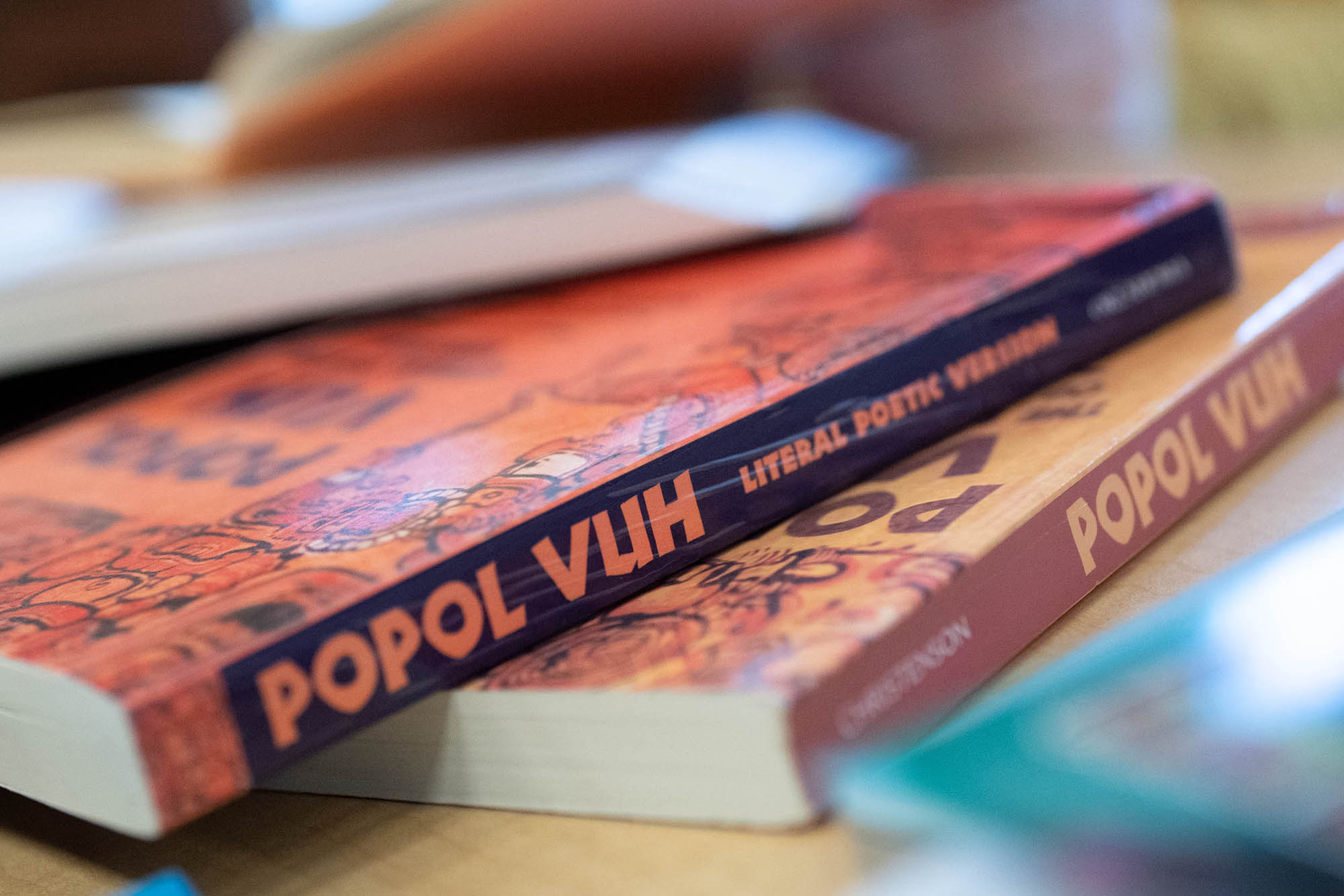 Stack of Books that read Popol Vuh Literal Poetic Version